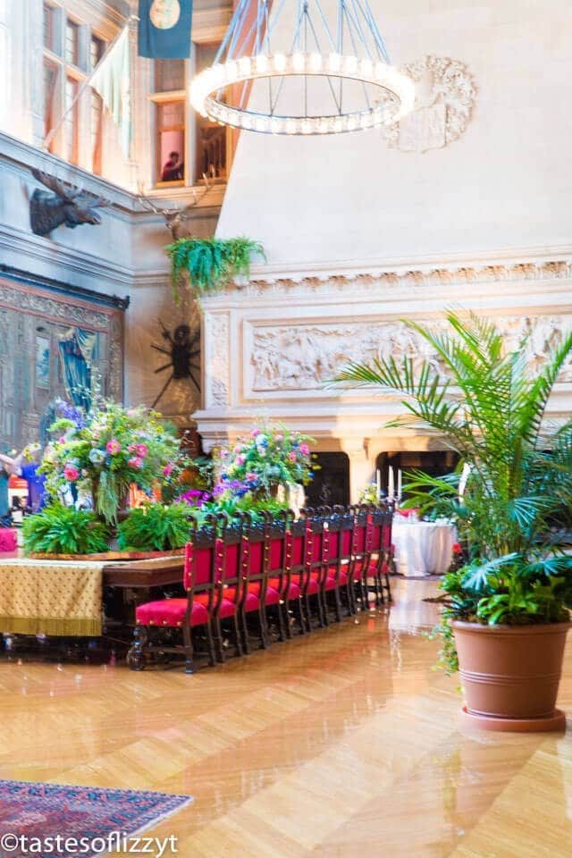 A room filled with furniture and vase of flowers on a table