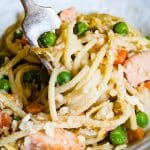 A close up of a plate of food with pasta, chicken and veggies