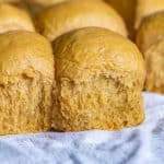 pumpkin dinner rolls on a white piece of paper