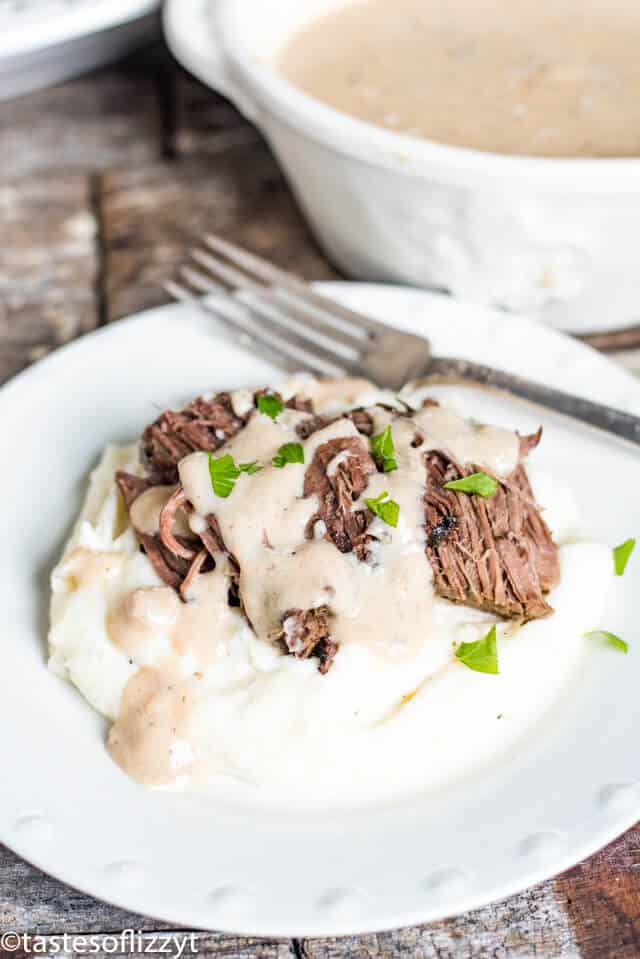 pot roast with potatoes and gravy on a plate