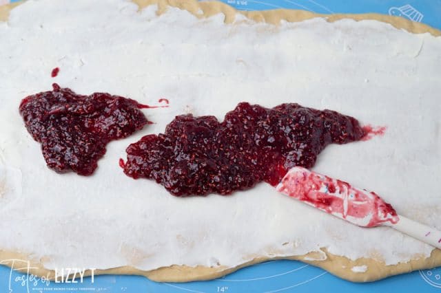 raspberry and cream cheese spread on dough