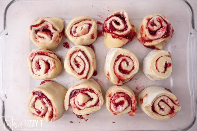 cut raspberry rolls in a baking pan