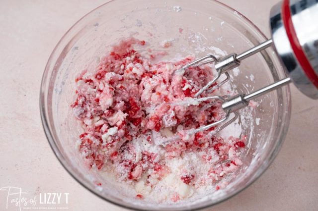 using a hand mixer for raspberry frosting