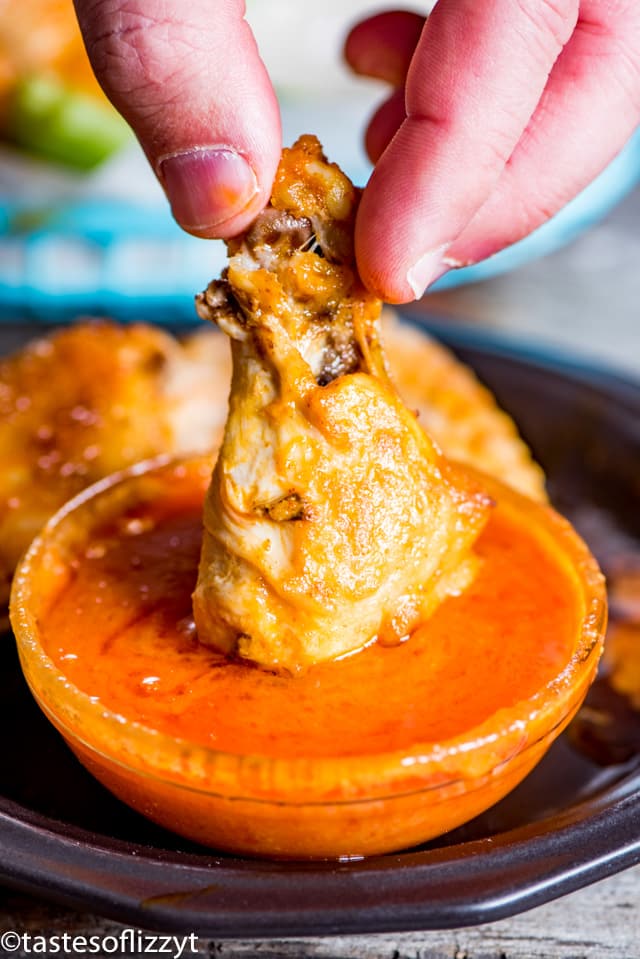 chicken wing dipping in sauce