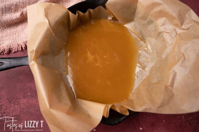 caramel sauce poured in a parchment paper lined skillet