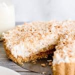 coconut cheesecake tart with one slice missing