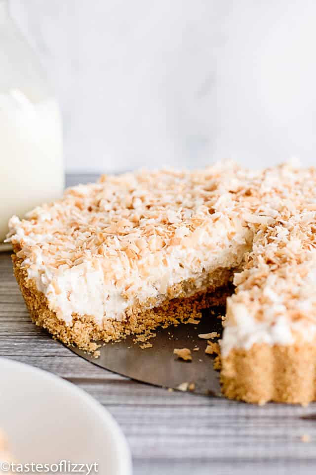 coconut cheesecake tart with one slice missing