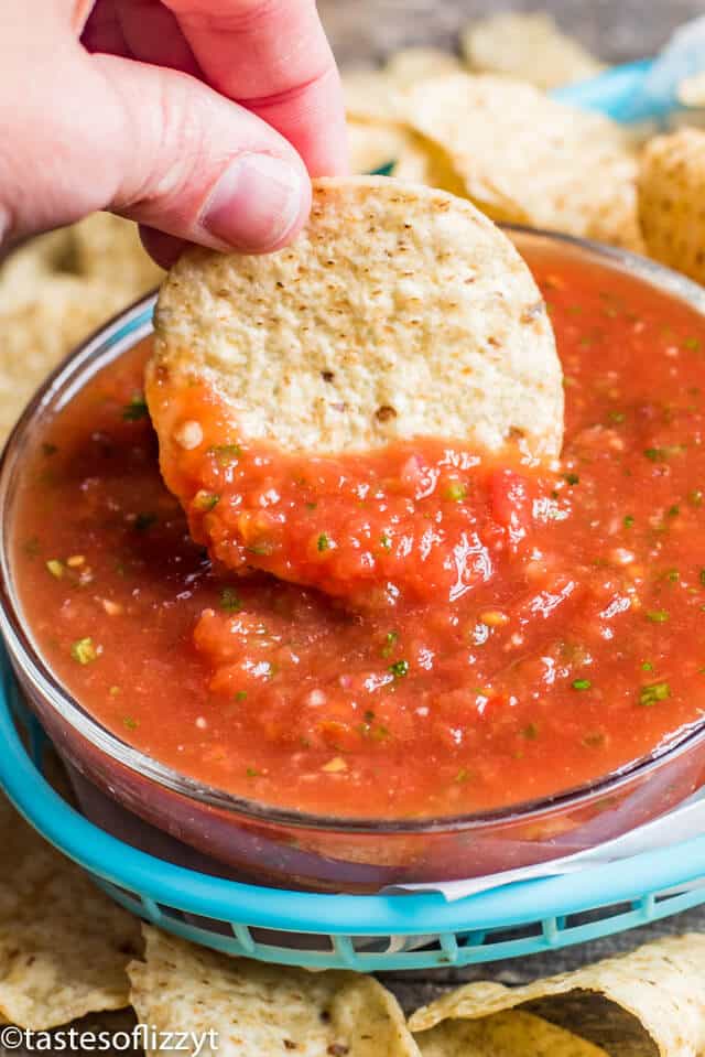 tortilla chip dipping in salsa