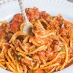 spaghetti with meat sauce on a plate with a fork