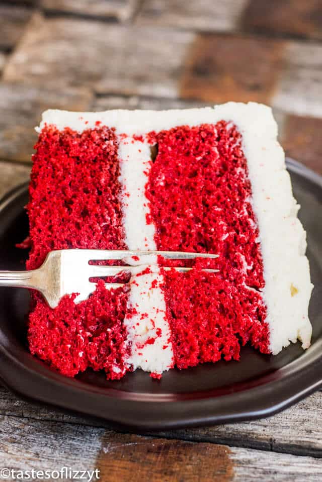 A close up of a piece of cake on a plate, with Red velvet cake and Cream