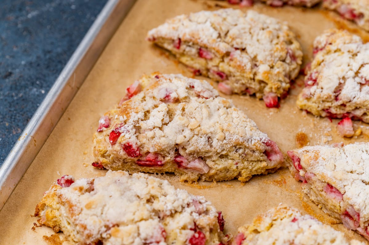 baked strawberry scones on a parchment lined baking pan