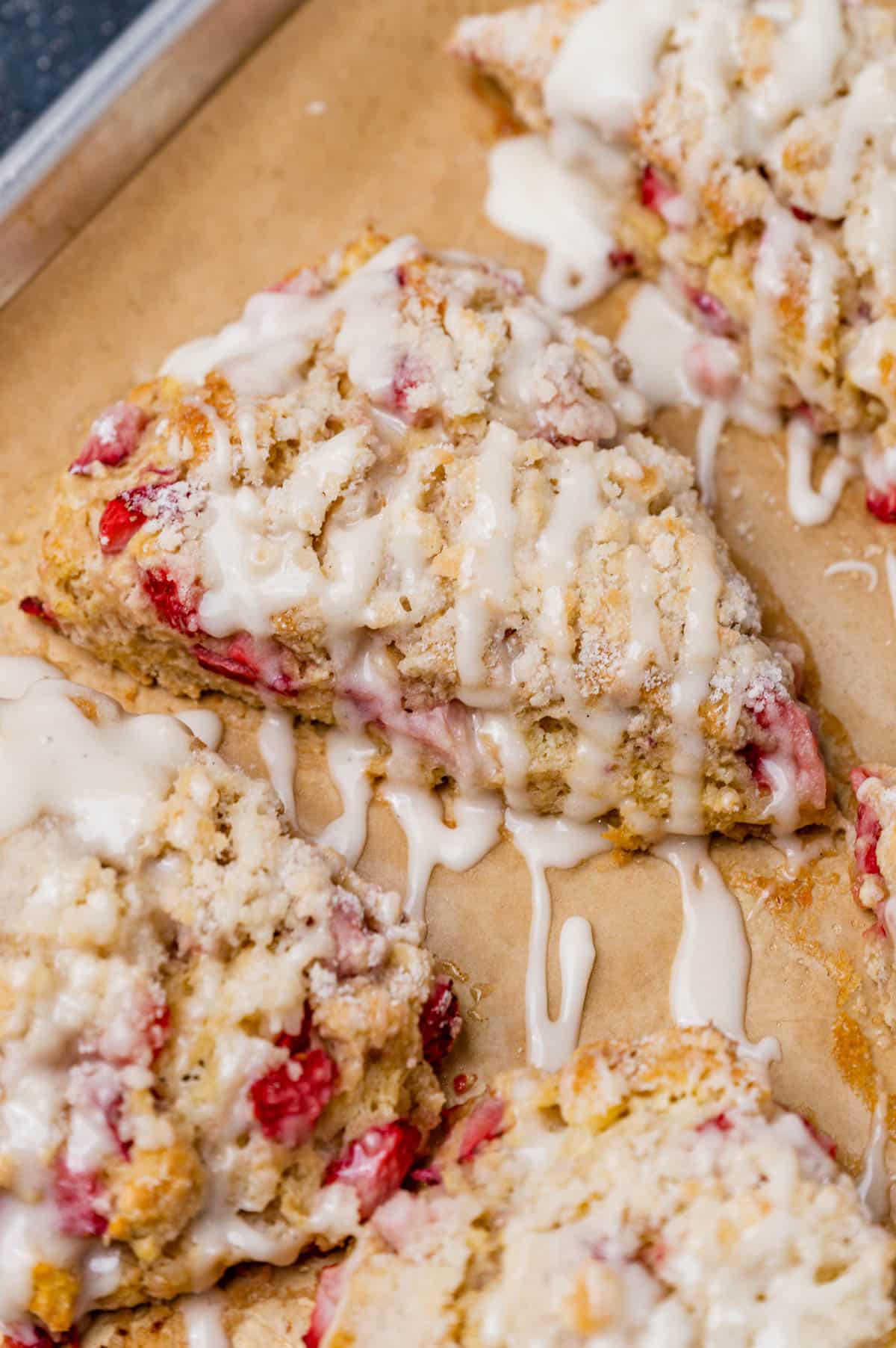closeup of strawberry scones with streusel and glaze