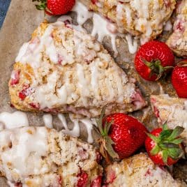 glazed strawberry scones on parchment paper