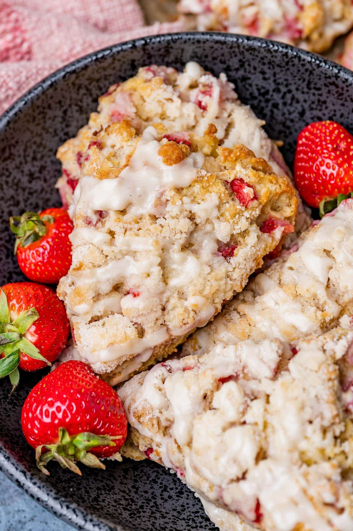 strawberry scones in a bowl with fresh strawberries