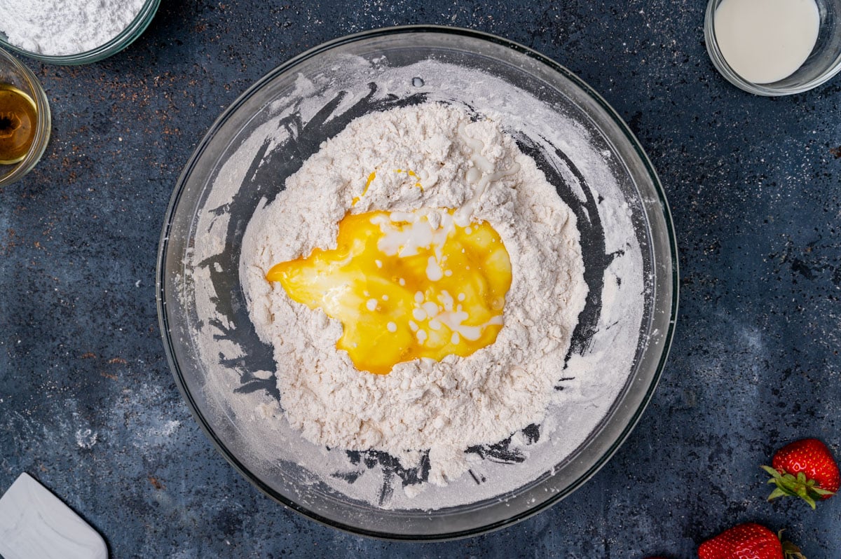 buttermilk and eggs over dry ingredients in a bowl