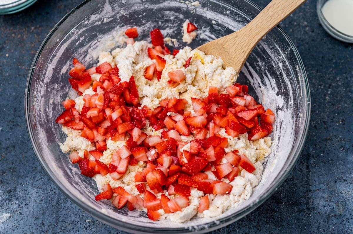 scone dough in a bowl with strawberries on top