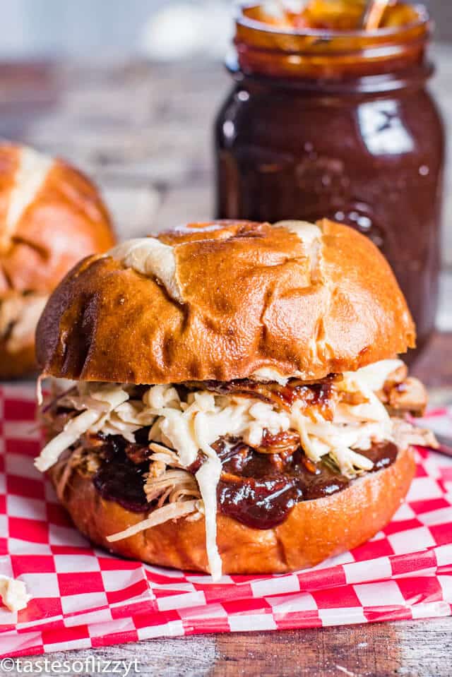 pulled pork sandwich on a pretzel bun