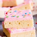 stack of sugar cookie bars with pink frosting