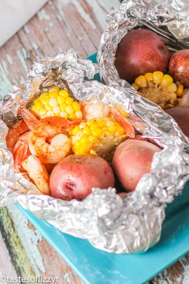 a packet of food sitting on top of a table, with corn and potatoes