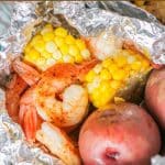 Whether you are camping or cooking at home, these easy grilled shrimp foil packets with fresh corn and potatoes are a quick 30 minute dinner recipe. 