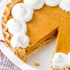 homemade pumpkin pie recipe with a slice taken out of the pie