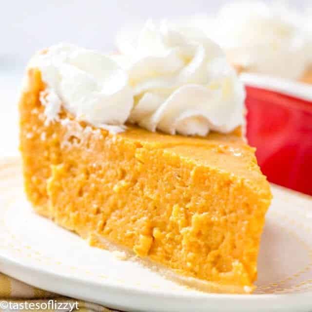 a slice of sweet potato pie topped with whipped cream