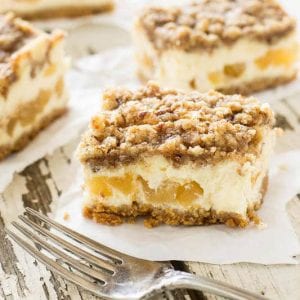 Caramel Apple Cheesecake Bars with a sweet brown sugar streusel baked on top. You love the swirls of caramel and apple pie filling inside.