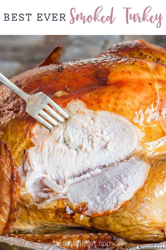 A close up of a smoked turkey with slice out