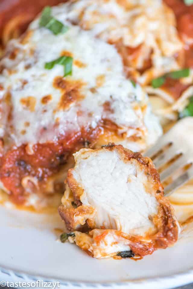 A close up of chicken parmesan on a plate