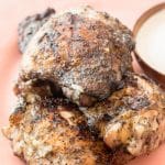 How to grill chicken thighs with simple flavoring. Serve low carb white barbecue sauce alongside this easy chicken thigh recipe for a delicious dinner!