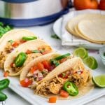 chicken tacos on a table with an instant pot