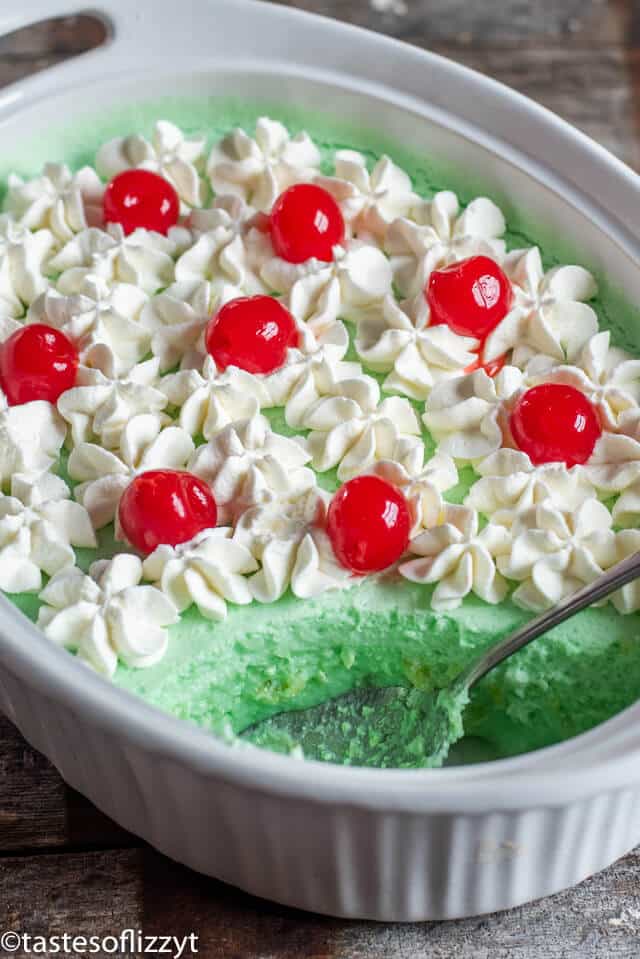 lime jello salad in a serving dish with a spoon