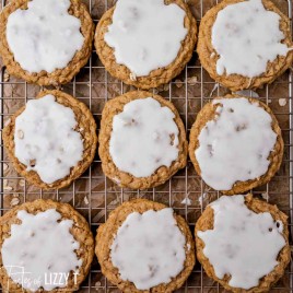 iced oatmeal cookies on a cooling rack