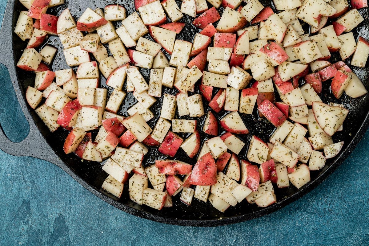 uncooked potatoes on a cast iron pan