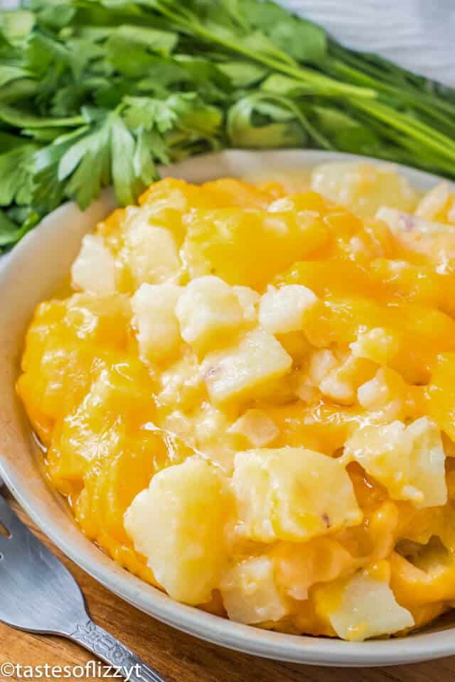 A close up of a bowl of cheese potatoes with velveeta 