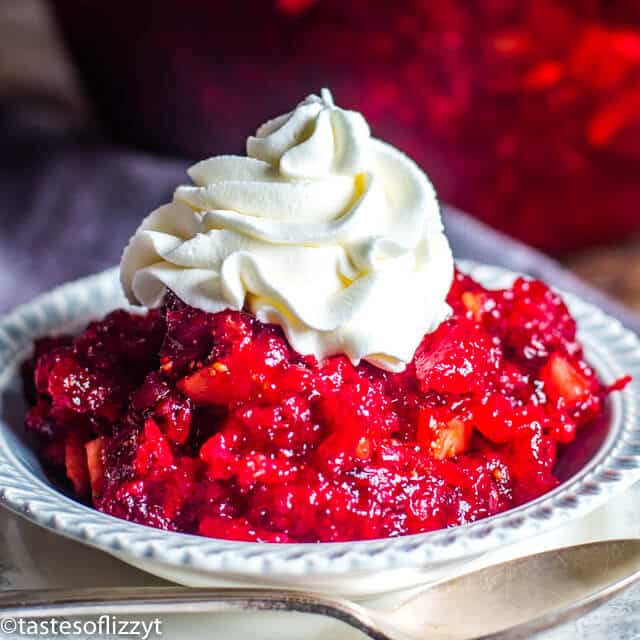 A close up of a bowl of fruit, with Jello salad