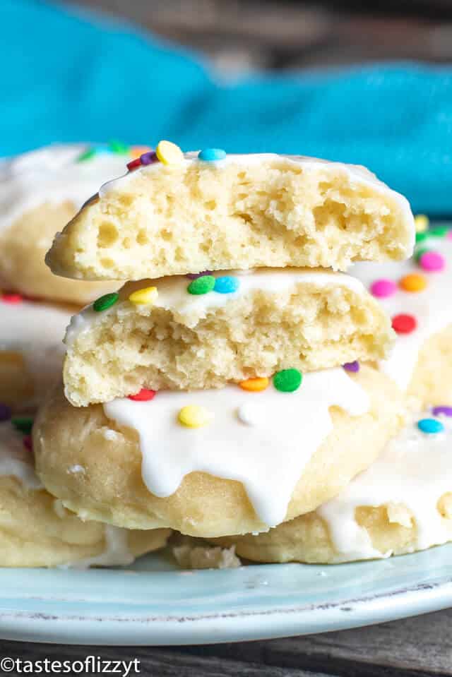 A close up of ricotta cookies with one broken in half