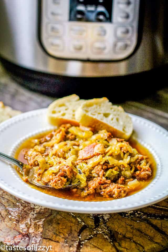 A plate of food on a table, with Soup and Sausage