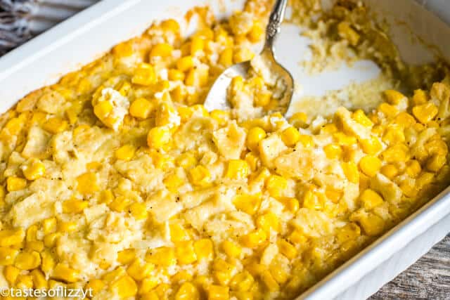 baked scalloped corn in a dish with a spoon