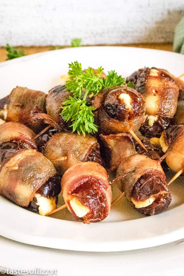 A plate of food, with bacon wrapped dates