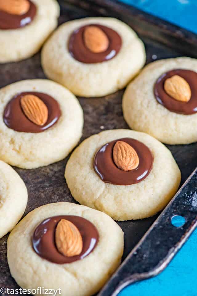 chocolate almond thumbprint cookies on a baking sheet