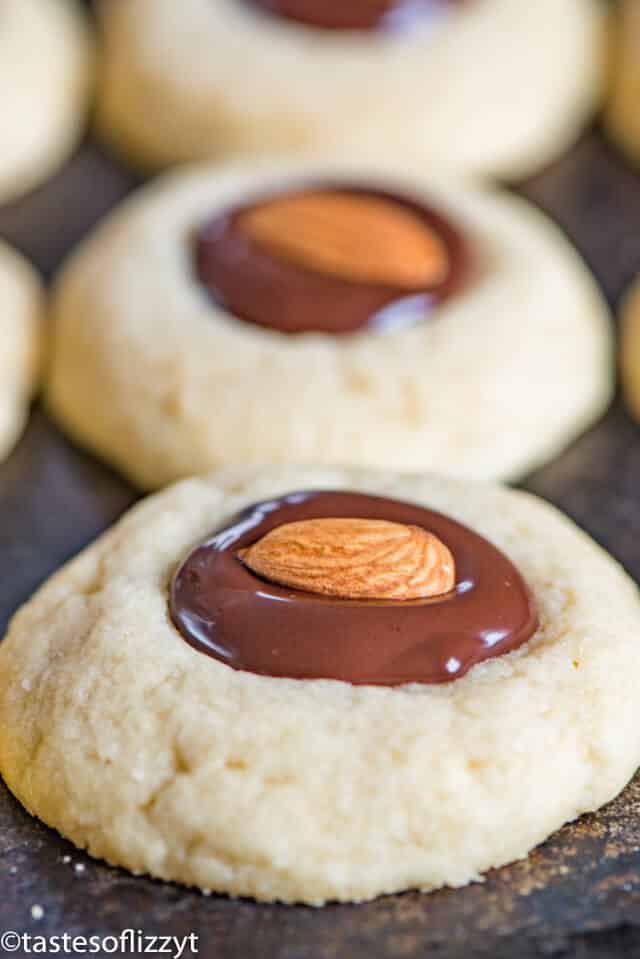 A close up of a chocolate almond cookie