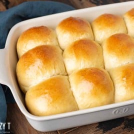 12 sourdough rolls in a white baking pan