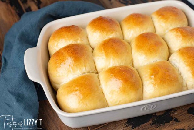 12 sourdough rolls in a white baking pan