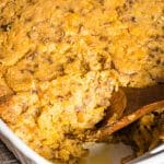 taco casserole in pan with a wooden spoon