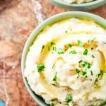 bowl of mashed potatoes with fresh sage leaves