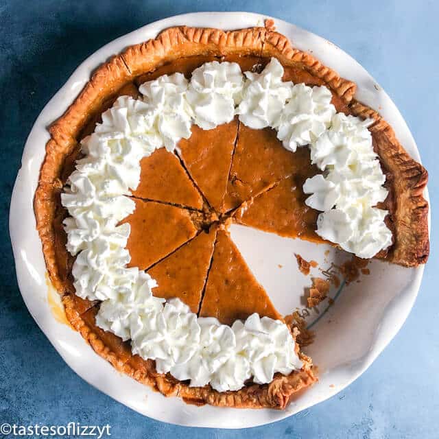 overhead view of eggnog pumpkin pie with one slice missing