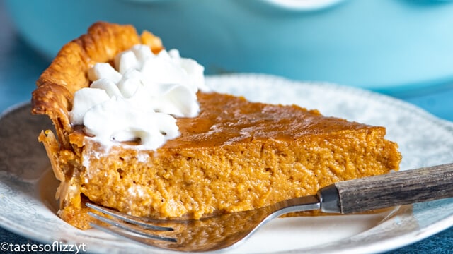 A piece of eggnog pumpkin pie on a plate with a fork