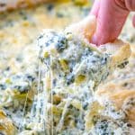 crostini bread in spinach artichoke dip