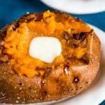 baked sweet potato with butter sitting on a plate